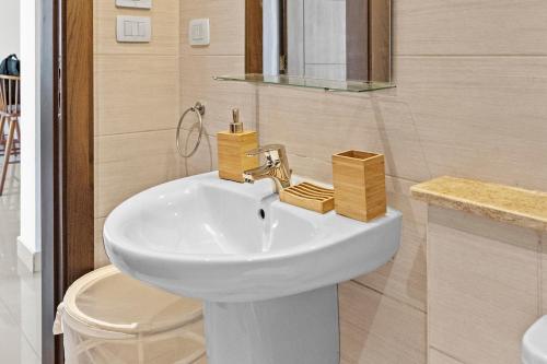 a bathroom with a white sink and a toilet at The G Cribs Sunlit - El Gouna in El Gouna