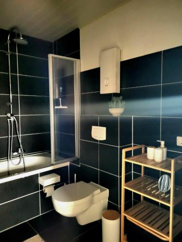 a bathroom with a toilet and a sink and a shower at Weltmann`s Hotel & Restaurant in Ennepetal