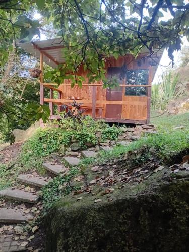 a small house on a hill with some stairs in front at Macheta Climbing House in Machetá