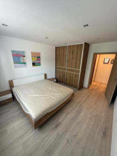 a bedroom with a bed and a wooden floor at Thurzova Residence 5 in Martin