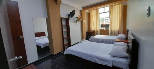 Ένα ή περισσότερα κρεβάτια σε δωμάτιο στο Hospedaje Amarantha