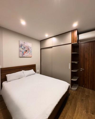 a bedroom with a large bed and a closet at Studio 3 ByhomeLinh Phố Cổ Hoàn Kiếm in Hanoi