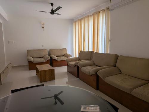 a living room with a couch and a table at 3 bhk apartment for rent in Kakkanad near infopark in Kakkanad