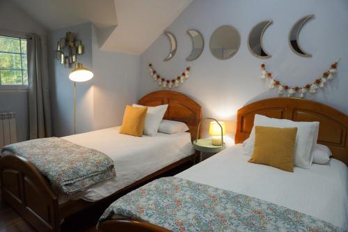 a bedroom with two beds and a moon sign on the wall at Villa Amalia 
