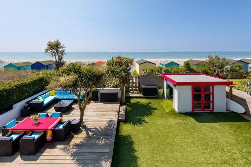 a backyard with a picnic table and a play house at The Kite House in East Wittering