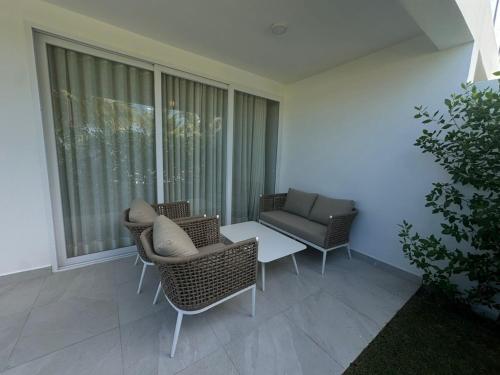 Khu vực ghế ngồi tại A104 - PRADOS · Peaceful 2BR Poolside Retreat • Punta Cana Getaway
