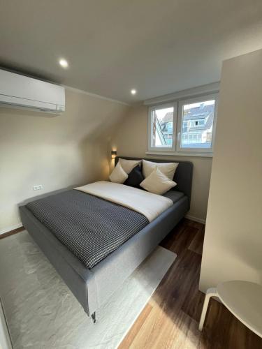 a bedroom with a bed in a small room at Lumio Apartment 2 - Klimatisiert - Coffee for free - in Karlsruhe