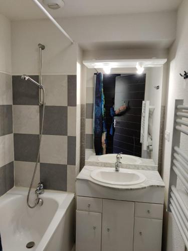 a bathroom with a sink and a tub and a shower at Résidence Pyrénées Zenith in Luz-Saint-Sauveur
