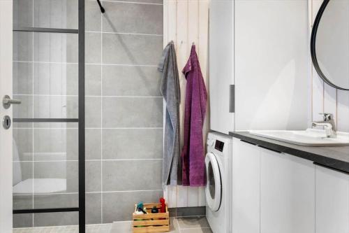 a bathroom with a shower and a washing machine at 1071-Thisted-Gravsesvej-30 in Klitmøller