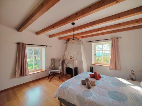 En eller flere senge i et værelse på Le Repaire de la Chouette