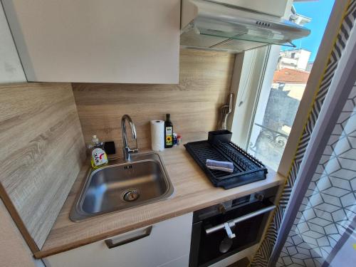 a kitchen counter with a sink and a window at L'industriel - Lourdes Centre in Lourdes