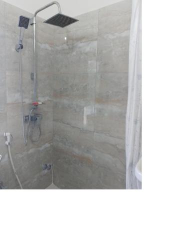 a bathroom with a shower with a shower curtain at Maison Etoile De Mer 2 in Skhirat