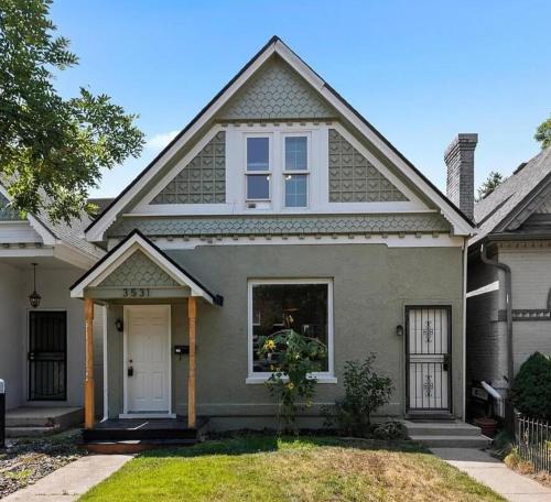 a gray house with a white door at The Green House, RiNo in Denver