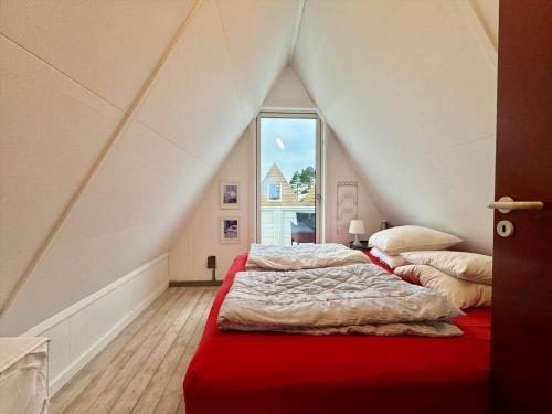 two beds in a attic room with a window at M398-Gedser-Gedser-Feriepark-32 in Gedser