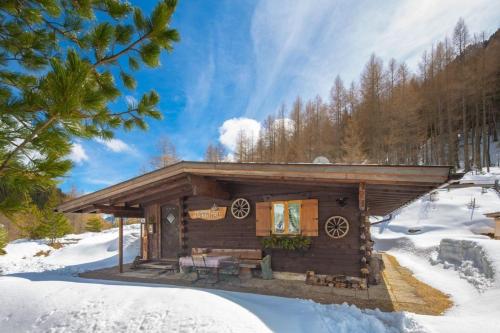 a log cabin with snow on the ground at Bergkristall Hütte in ruhiger Panoramalage in Sankt Sigmund im Sellrain