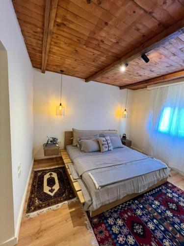 a bedroom with a large bed and a rug at Hathors Terrace Apartment in Luxor