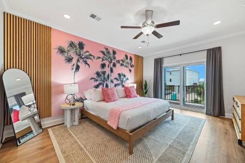 a bedroom with a bed with a painting of palm trees at Bright Waves Fort Morgan in Gulf Shores