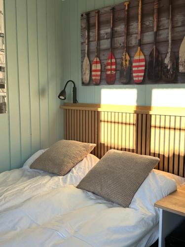 two beds in a room with bowls on the wall at Anekset in Sandefjord