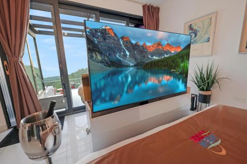 a flat screen tv on a wall in a living room at The View Luxe Boutique Hotel 