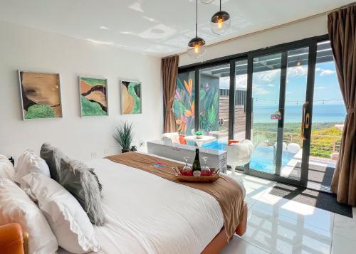 a bedroom with a bed and a view of the ocean at The View Luxe Boutique Hotel 
