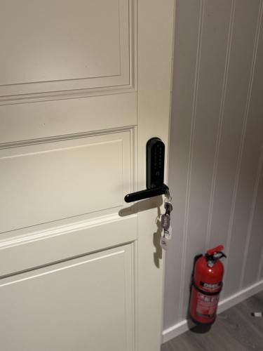 a fire hydrant is sitting next to a door at Rosenli Gård in Tønsberg