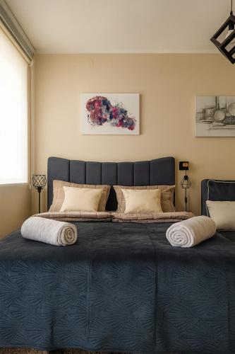 a bedroom with a large bed with a blue blanket at GALAKTIK centar in Apatin