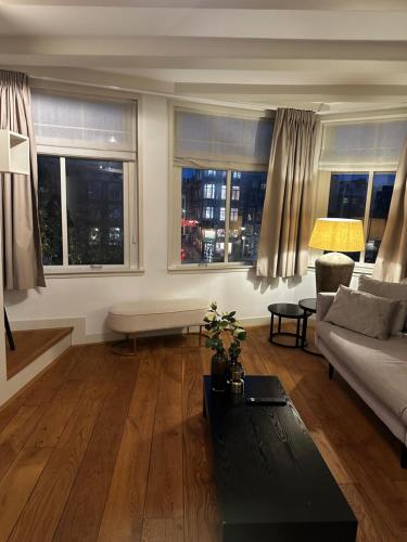a living room with a couch and two windows at Boutique LaBeau in Amsterdam