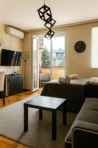 a living room with a bed and a table at GALAKTIK centar in Apatin