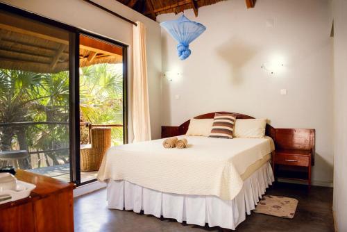 Ένα ή περισσότερα κρεβάτια σε δωμάτιο στο Lagoon Bay Chidenguele