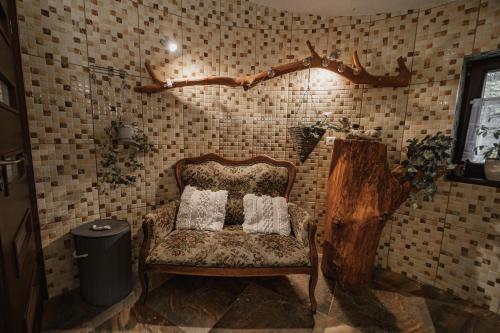 a room with a chair with two pillows on it at Dovolenkový dom Dubak in Lopej