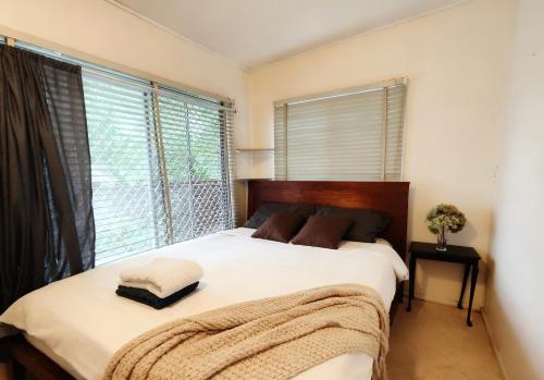 a bedroom with a bed with a blanket on it at Quiet Guest Room in Burwood in Sydney