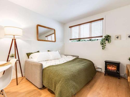 a bedroom with a bed and a fire place at LE COZY - Mont Sainte-Anne in Beaupré