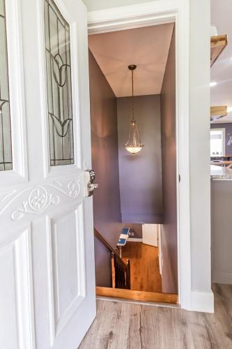 an open door leading into a hallway with a staircase at All Seasons Resort with Lake Access in Georgetown