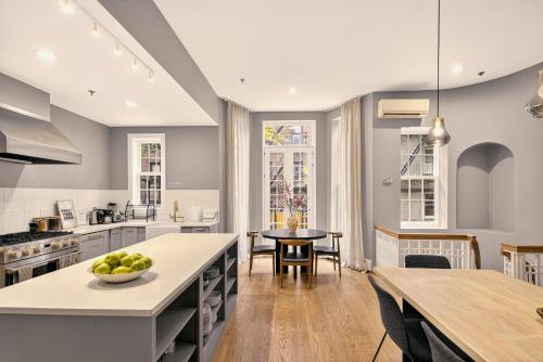 a kitchen with a table and a dining room at Outsite Chelsea in New York