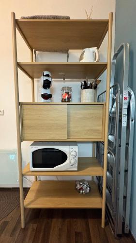 a shelf with a microwave on it in a room at Enjoy Wien in Vienna