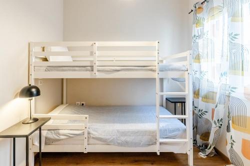 a bedroom with two bunk beds and a desk at Monemvasia modern flat nearby sea in Monemvasia