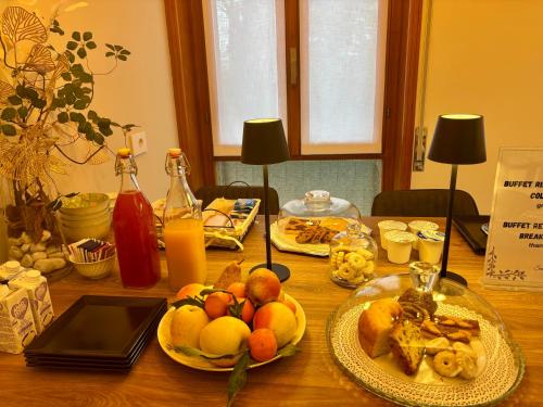 a wooden table with plates of food on it at Salotto Santa Franca in Piacenza