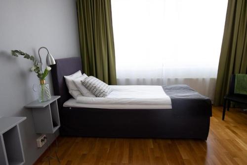 a bed in a room with a large window at City Central Hotel Örebro by First Hotels in Örebro