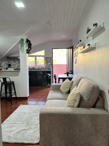 a living room with a couch and a kitchen at Quiet Cozy Apt MQ2 & Near Beach & Mountain View in Calheta