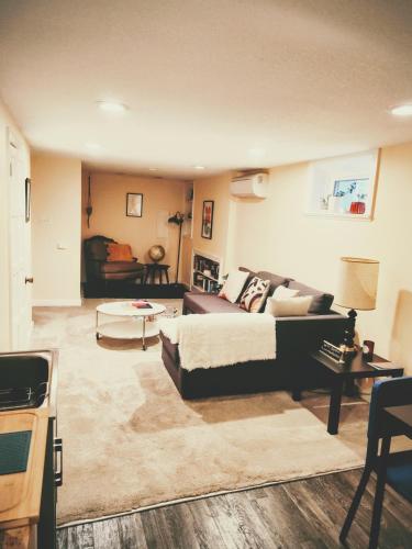 a living room with a couch and a table at Sweet Beech St Retreat-Basement Apt in Portland