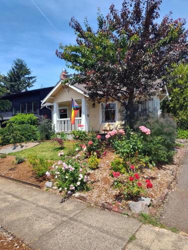 a house with flowers in the front yard at Sweet Beech St Retreat-Basement Apt in Portland
