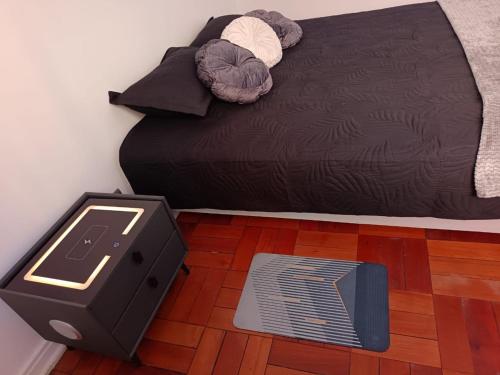 a bedroom with a bed and a floor with a heater at GuestHouse Habitaciones SANTIAGO CENTRO in Santiago