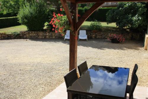 un tavolo e sedie sotto un baldacchino in un cortile di Le Lou Secadou a Saint-André-dʼAllas