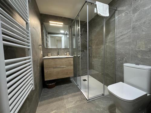 a bathroom with a shower and a toilet and a sink at Villmor - B11 - Pichirillo in Benasque