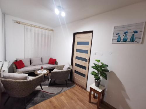 a living room with a couch and a table at Privat Teo Podtureň in Liptovský Mikuláš