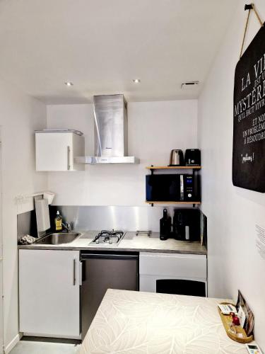 a small kitchen with a sink and a stove at SKY - Gîte meublé & confort Drôme - Écolodgîte in Laveyron