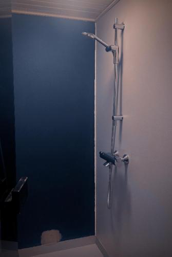 a shower stall with a bike hanging on a wall at Arctic circle cabin 3 in Rovaniemi