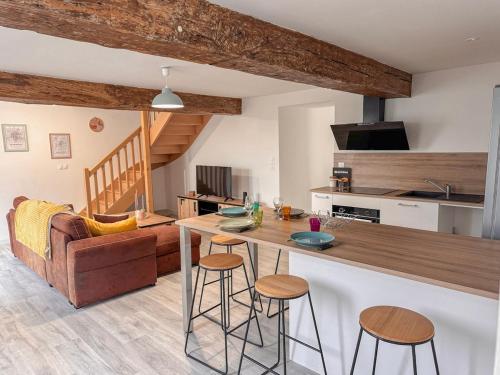 a kitchen and living room with a table and chairs at Entre Bressuire & Thouars- By R&G in Coulonges-Thouarsais