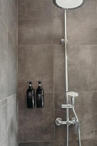 a shower with two bottles of soap in a bathroom at Canhoto Douro in Marco de Canaveses