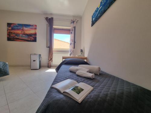 a bedroom with a bed with two books on it at House Calamigna in Ventimiglia di Sicilia